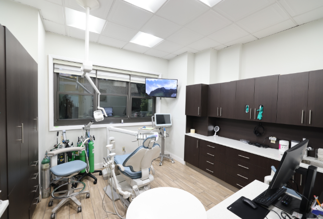 A dentist treating a patient in a New York dental office